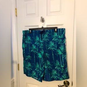 Men’s Bathing Suit.  New with tags.  Size XXL Blue/green print . Side pocket